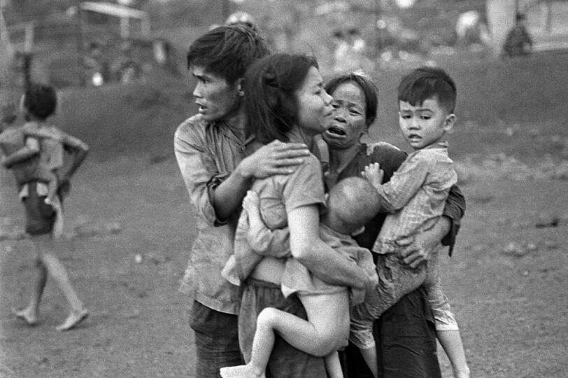 Südvietnamesische Zivilisten drängen sich nach einem Angriff der Regierungstruppen zusammen, welche die Post von Dong Xoai zurückerobern wollen. Sie sind unter den wenigen Überlebenden von zwei Tage währenden schweren Kämpfen.