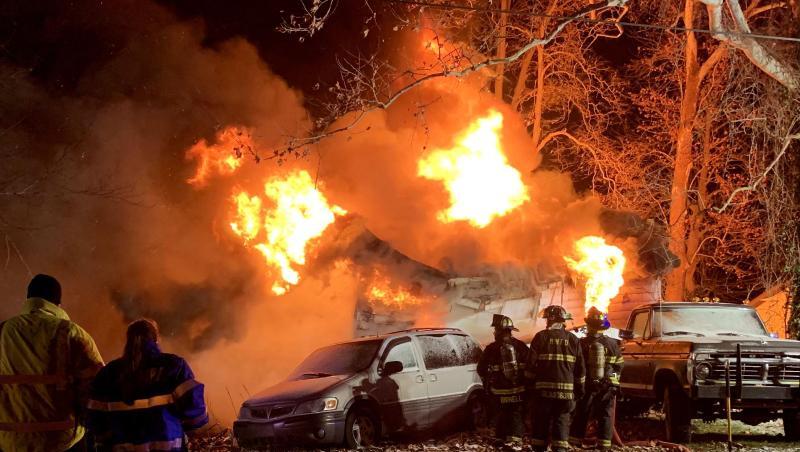 Feuerwehrleute stehen vor dem brennenden Haus am Stadtrand von Logansport. Feuerwehrleute stehen vor dem brennenden Haus am Stadtrand von Logansport.