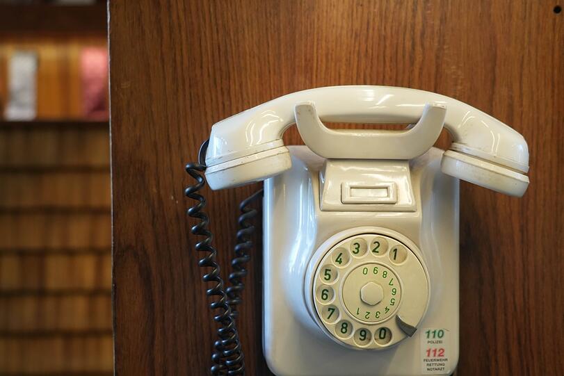 Mit Kabel und Wählscheibe: Das Telefon hängt nicht zur Zierde an der Wand, es ist noch im Einsatz!