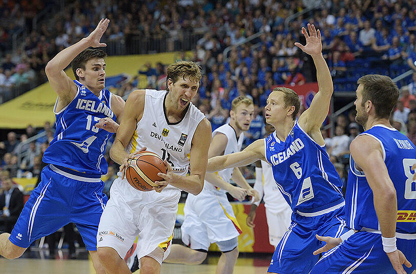 Dirk Nowitzki (M) hat gegen die Isländern Hördur Vilhjalmsson (l-r), Jakob Sigurdarson und Hlynur Baeringsson den Ball gesichert.