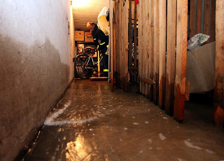Schlimmer noch hat es Nürnberg erwischt. Hier gab es zahlreiche überflutete Keller und Straßen. Im Bild schiebt ein Mitarbeiter des Technischen Hilfswerks (THW) mit einem Besen Wasser aus einem Kellerabteil.