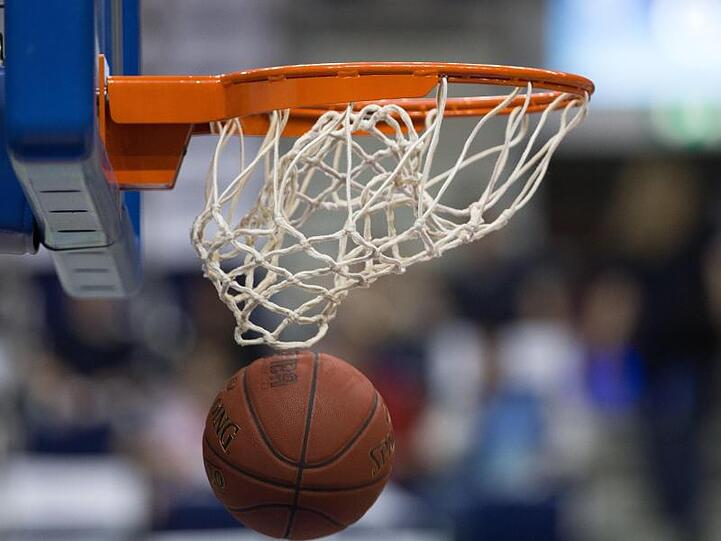 Ein Basketball fällt durch das Netz vom Basketballkorb. Foto: Lukas Schulze/Archiv