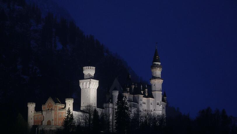 Von Scheinwerfern angestrahlt steht das Schloss Neuschwanstein im Königswinkel.