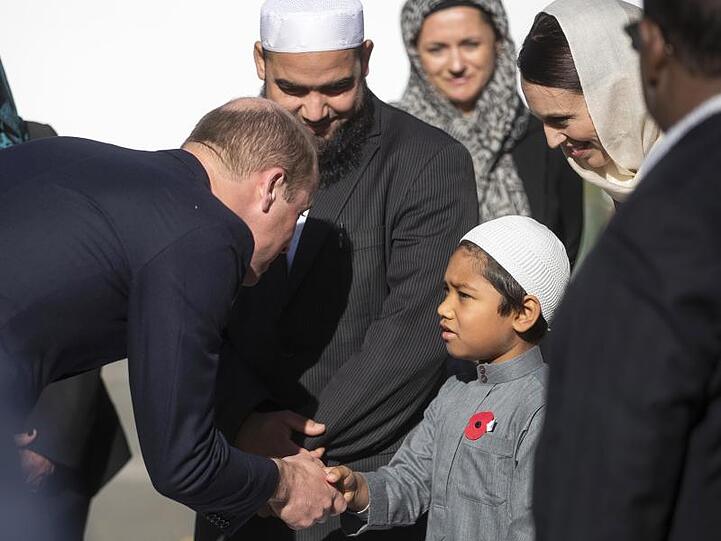 Prinz William (l) begrüßt in der Al-Noor-Moschee ein junges muslimisches Gemeinschaftsmitglied neben Jacinda Ardern (2.v.r), Premierministerin von Neuseeland.