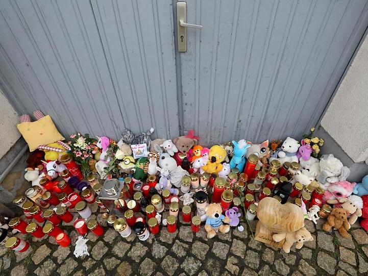 Kerzen und Plüschtiere vor dem Eingang des Hauses, in dem die Sechsjährige ums Leben kam.
