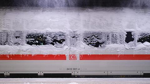 Ein verschneiter ICE steht im Hauptbahnhof von Hannover. "Schnee und Eis werden den Nah- und Fernverkehr der DB in weiten Teilen des Landes auch am Montag beeinträchtigen", teilte die Deutsche Bahn mit.