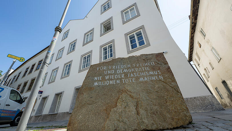 Ein Stein mit der Aufschrift "F&uuml;r Frieden, Freiheit und Demokratie. Nie wieder Faschismus, Millionen Tote mahnen" steht vor dem neuen Polizeizentrum im Hitler-Geburtshaus.