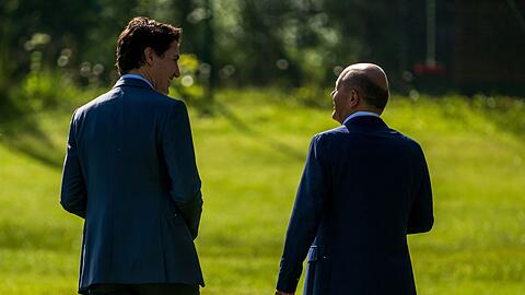 Bundeskanzler Olaf Scholz (SPD), geht neben Justin Trudeau (r) beim G7-Gipfel auf Schloss Elmau.