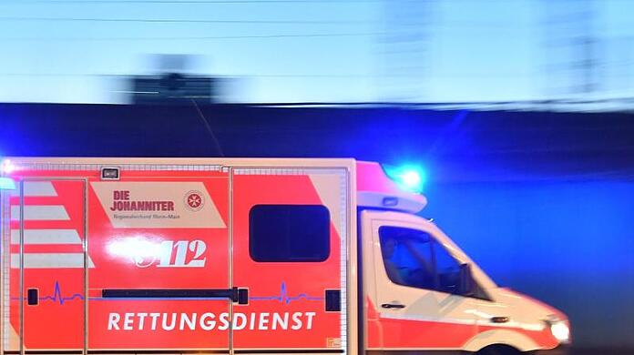 Ein Rettungswagen ist mit eingeschaltetem Blaulicht im Einsatz.
