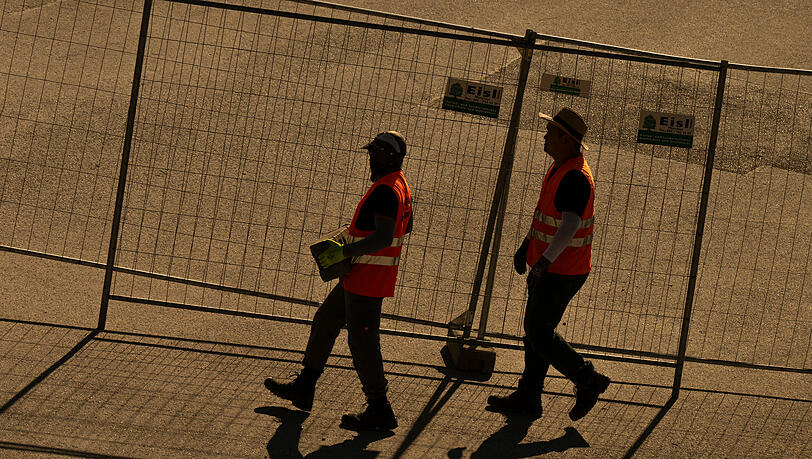 Arbeiter montieren am Mittwoch (25. Juni) in den frühen Morgenstunden einen Bauzaun rund um die Theresienwiese. Arbeiter montieren am Mittwoch (25. Juni) in den frühen Morgenstunden einen Bauzaun rund um die Theresienwiese.