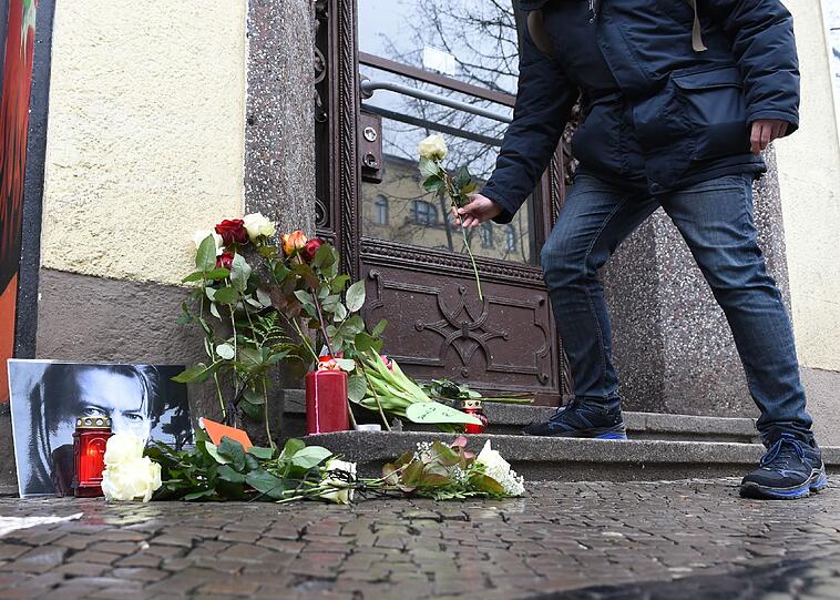 Die Trauer um David Bowie ist weltweit groß. Hier legt ein Fan eine Blume vor dem Haus ab, in dem der Popstar während seiner Zeit in Berlin gewohnt hat.