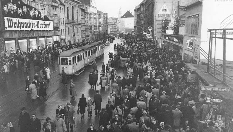 Weihnachts-Verkauf! Die von Behelfsbauten gesäumte Neuhauser Straße mit dem Karstadt Oberpollinger im adventlichen Trubel. Weihnachts-Verkauf! Die von Behelfsbauten gesäumte Neuhauser Straße mit dem Karstadt Oberpollinger im adventlichen Trubel.