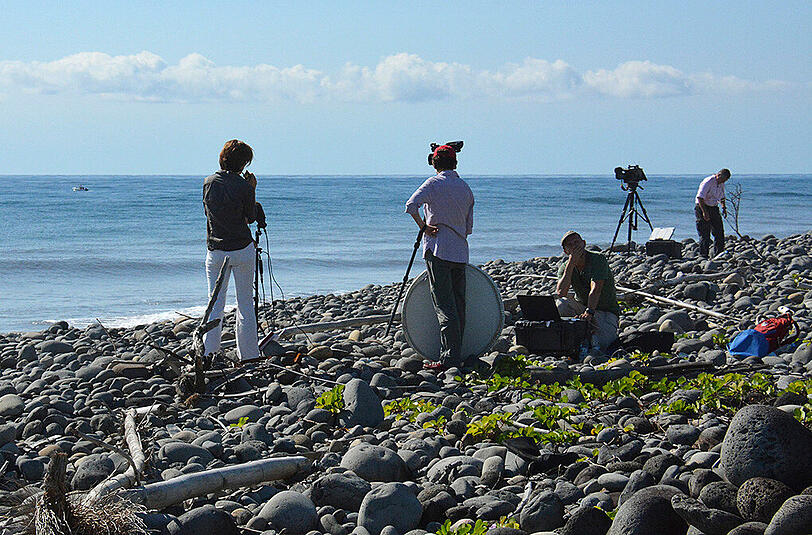 Filmcrews stehen an dem Ort auf der Insel La Réunion im indischen Ozean, wo das Wrackteil einer Boeing 777 angespült wurde.