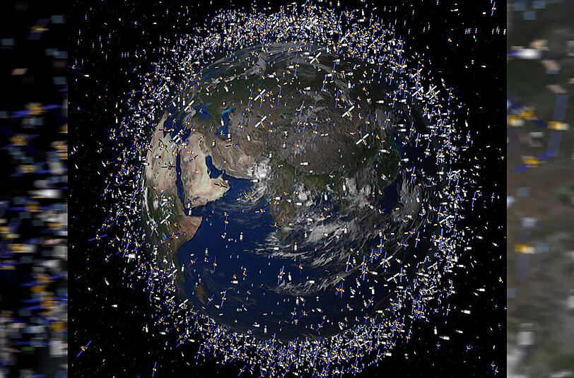 Ganz schön zugemüllt: Das computergenerierte Bild der European Space Agency (ESA) zeigt Weltraummüll früherer Weltraummissionen, der neben intakten Satelliten um die Erde kreist.