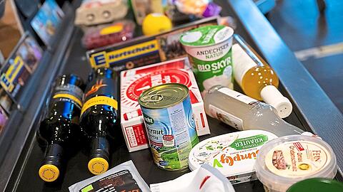Lebensmittel liegen in einem Supermarkt auf einem Kassenband. Der dafür zu zahlende Betrag wächst weiter. Dashat mehrere Gründe. Foto: Sven Hoppe/dpa