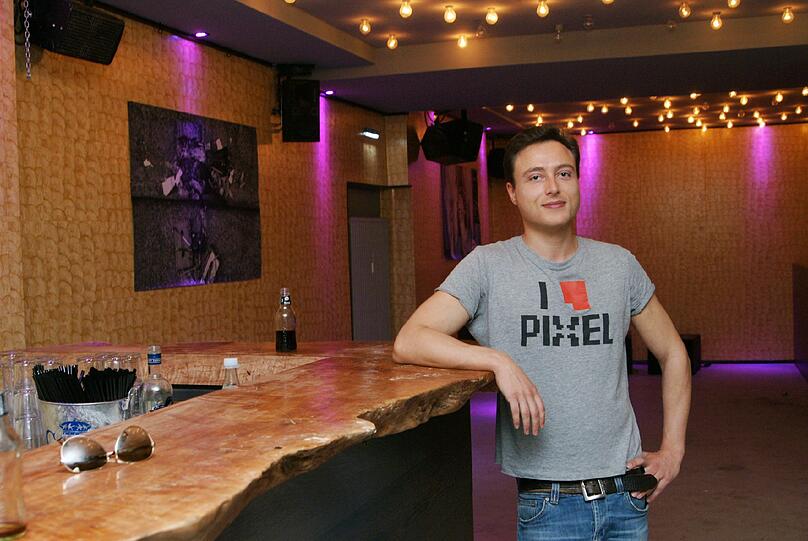 Oben die alten Glühbirnen aus der Blumenbar, vorne der Tresen aus Litschi-Holz, dahinter die Muscheltapete: Geschäftsführer Bernhard Holiga in der neuen &bdquo;Soho Teabar&ldquo;.