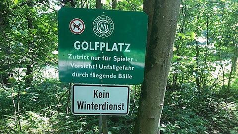 "Golfplatz - Zutritt nur für Spieler. Unfallgefahr durch fliegende Bälle" steht auf einem der Schilder.