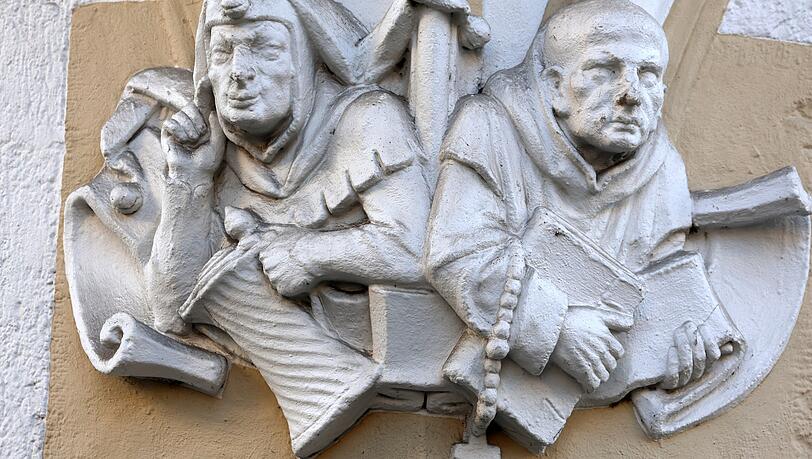 Narr und M&ouml;nch &ndash; eine Allegorie auf die Freuden (Bier) und Entbehrungen (Buch und Rosenkranz) des Lebens &ndash; entdeckt an einer Hausfassade in der Thierschstra&szlig;e 22.