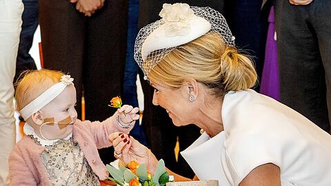 S&uuml;&szlig;e Begegnung im Zentrum f&uuml;r Kinderonkologie in Utrecht: Ein kleines M&auml;dchen reicht K&ouml;nigin M&aacute;xima eine Blume.