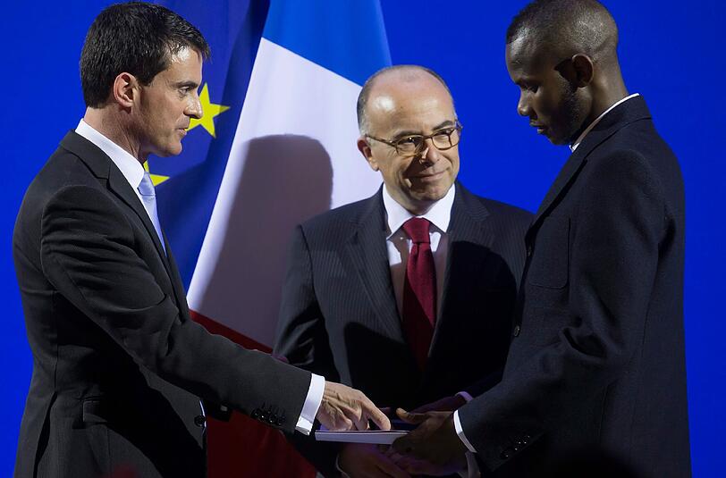 Lassane Bathily: Der 24 Jahre alte Flüchtling aus Mali erhielt am Dienstag in Paris von Ministerpräsident Manuel Valls seinen neuen Ausweis.