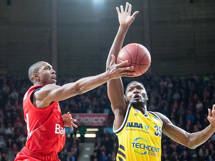 DeMarcus Nelson von München (l.) und Landry Nnoko von Alba Berlin kämpfen um den Ball. Foto: Matthias Balk/dpa