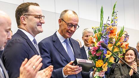 Jens Spahn (l.) überreicht Friedrich Merz zu seinem 70. Geburtstag neue Krawatten.