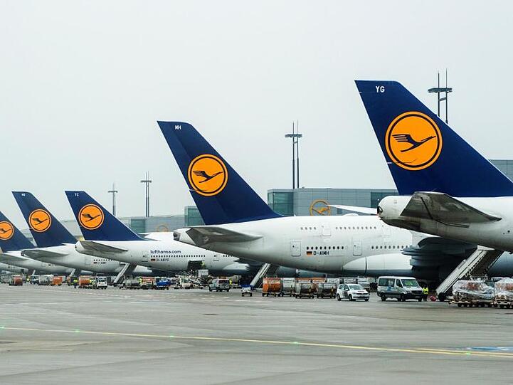 Flugzeuge der Lufthansa stehen am Flughafen. Foto: Christophe Gateau/dpa/Archivbild