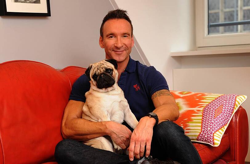 Jochen Bendel mit Mops Gismo in seiner Münchner Wohnung.
