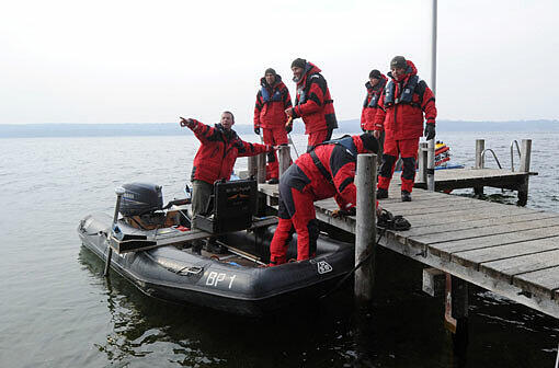 Einsatzkräfte der Polizei suchen auf Booten am 24.03.2013 nach einem vermissten Taucher in Allmannshausen am Starnberger See. Dort kam es zu einem Tauchunfall mit zwei Toten.