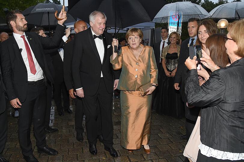 Erst schlupft Horst Seehofer unter Angela Merkels Schirm...