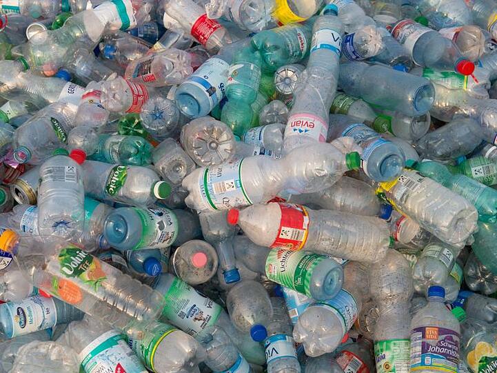 Viele Einwegflaschen aus Plastik liegen auf einem Haufen.
