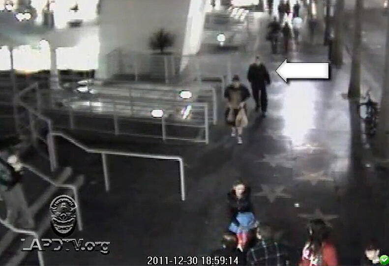Der Videograb vom 03.02.2012 einer Überwachungskamera, herausgegeben von der Polizei in Los Angeles, zeigt einen Mann (Pfeil), nach dem im Zusammenhang mit einer Feuerserie gefahndet wurde.