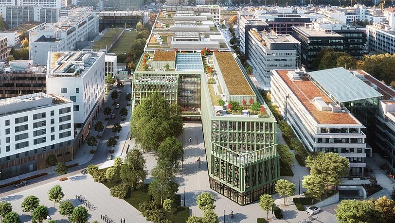 Eisenbahngrün leuchtet die Aluminiumfassade des Holzhybriden "i8" aus dem Büro- und Mischareal "iCampus" heraus. Insgesamt sollen direkt neben dem quirligen Werksviertel-Mitte einmal zehn große Bürogebäude stehen.