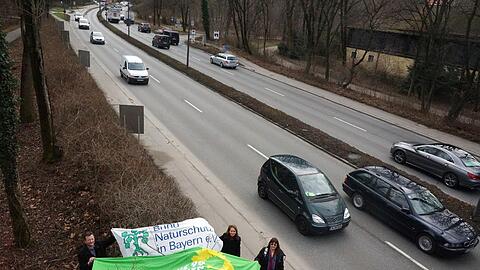Grüne und Bund Naturschutz demonstrieren mit einem Transparent gegen eine 3,50 Meter breite Spur.