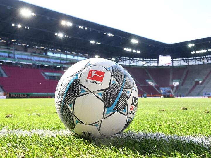 Ein Ball liegt auf dem Rasen in der WWK-Arena. Foto: Tobias Hase/dpa - Pool/dpa/Symbolbild