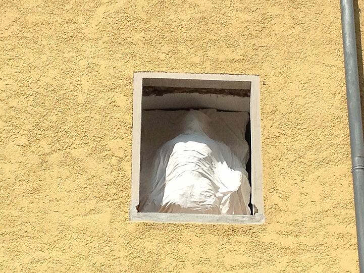 Mit einem Leinentuch verhüllt, springt er von Fenster zu Fenster.