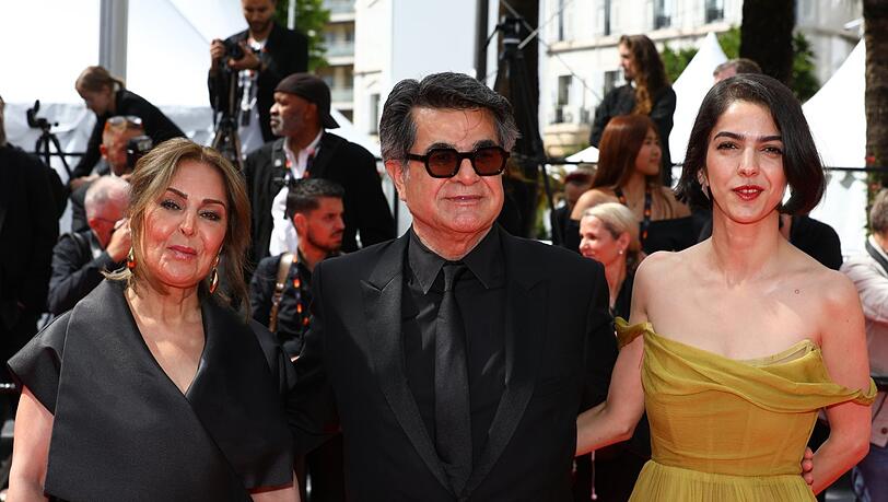 Der iranische Regisseur, Drehbuchautor und Produzent Jafar Panahi, seine Tochter Solmaz Panahi (r) und seine Frau Tahereh Saeedi auf dem roten Teppich vor der Premiere des Films "Un simple accident" auf dem 78. Internationalen Filmfestival in Cannes.
