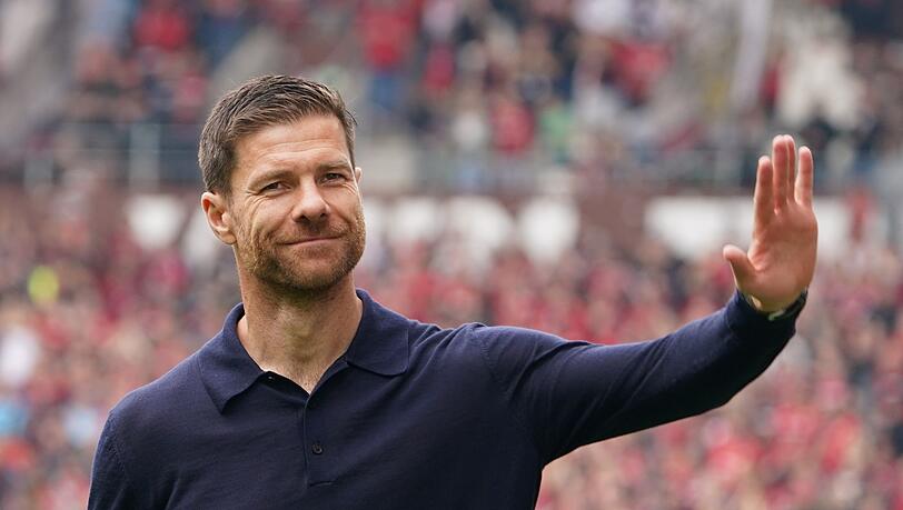 Leverkusens Trainer Xabi Alonso winkt nach Spielende den Fans zu.