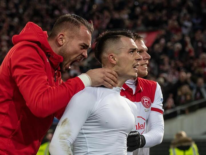 Düsseldorfs Erik Thommy (M) jubelt mit Florian Kastenmeier (l) und Rouwen Hennings über seinen Treffer zum 2:1.