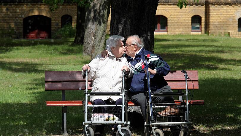 Haben gut küssen: Zwei Rentner genießen den Sommer ganz romantisch allein auf einer Parkbank. Haben gut küssen: Zwei Rentner genießen den Sommer ganz romantisch allein auf einer Parkbank.