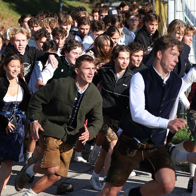 Die ersten Besucher rennen zum Start des Oktoberfestes nach dem Einlass auf die Festwiese zu den Zelten.