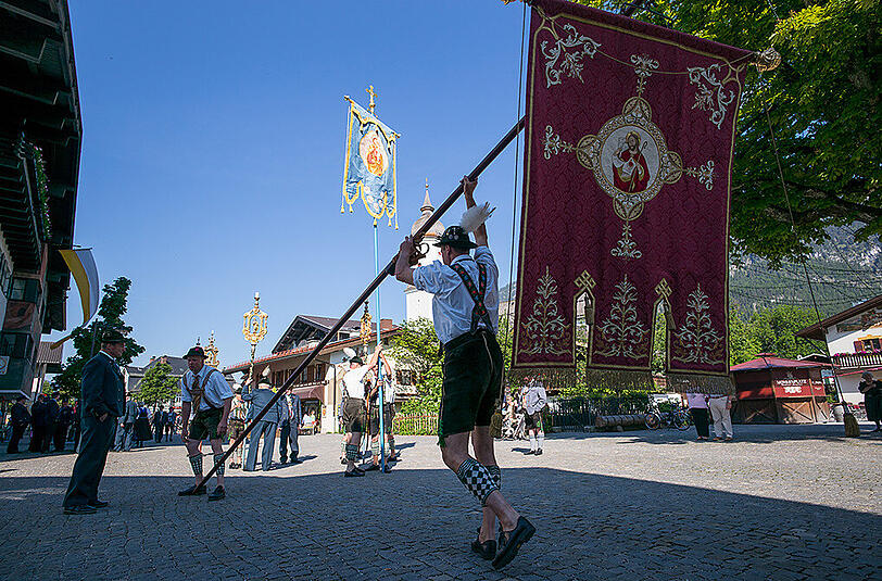 Katholiken ziehen zur Fronleichnamsprozession durch die Gemeinde Garmisch-Partenkichen.