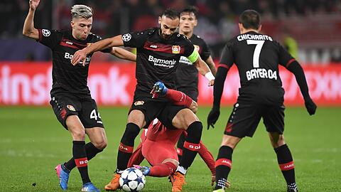 Ángel Correa (unten) von Atletico und Ömer Toprak (Mitte) von Leverkusen kämpfen um den Ball.