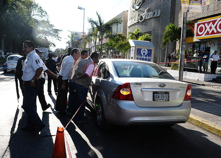 Ein Bild vom 17 Februar 2011 zeigt wie die Polizei ein abgestelltes Fahrzeug inspiziert, das abgetrennte Körperteile beinhaltet. In Acapulco gab es in den vergangenen Tagen mehrere Morde im Drogenmilieu.
