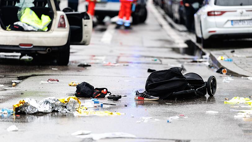Kleidung und ein Kinderwagen liegen nach dem Anschlag auf der Straße.
