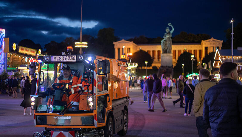 Mitarbeiter der Straßenreinigung abends auf der Theresienwiese.