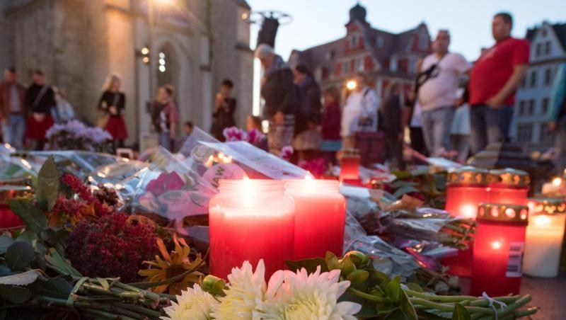 Menschen kommen nach einem ökumenischen Gedenkgottesdienst für die Opfer des Terroranschlags in Halle vor der Marktkirche in Halle (Saale) zusammen und stellen Kerzen ab.