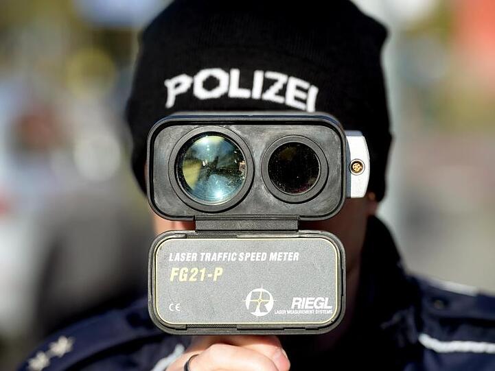 Genau hingeschaut: Ein Polizist hantiert in Brandenburg mit einem Geschwindigkeitsmessgerät.