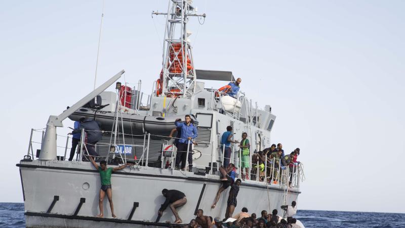 Libysche Flüchtlinge versuchen, an Bord eines Schiffs der libyschen Küstenwache zu gelangen. Libysche Flüchtlinge versuchen, an Bord eines Schiffs der libyschen Küstenwache zu gelangen.