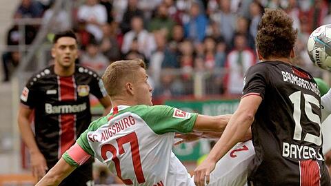Augsburgs Alfred Finnbogason (M) macht es akrobatisch.